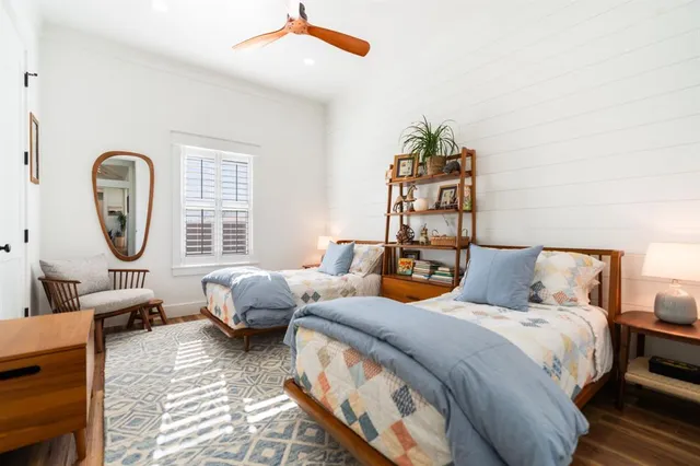 a bedroom with furniture and a large window