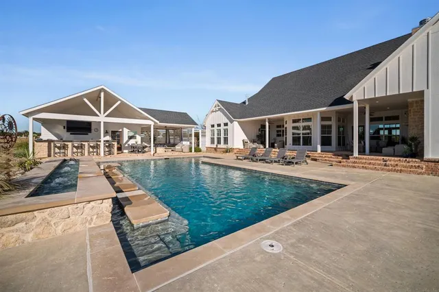 a view of a house with swimming pool and porch