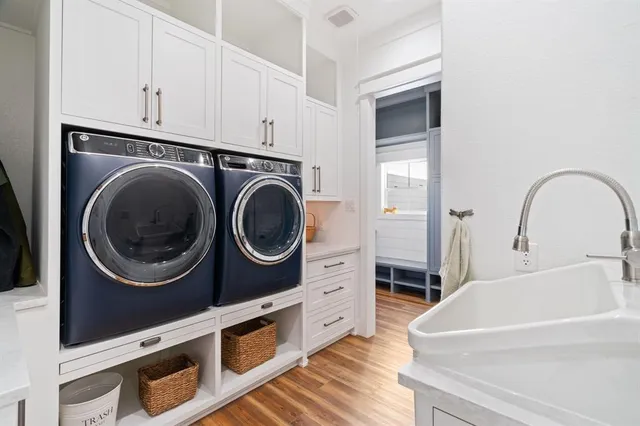 a kitchen with stainless steel appliances granite countertop a sink a stove and cabinets