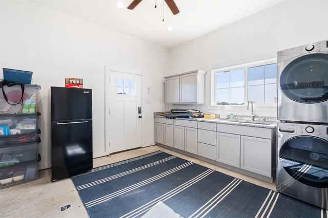 a kitchen with a refrigerator and a stove top oven