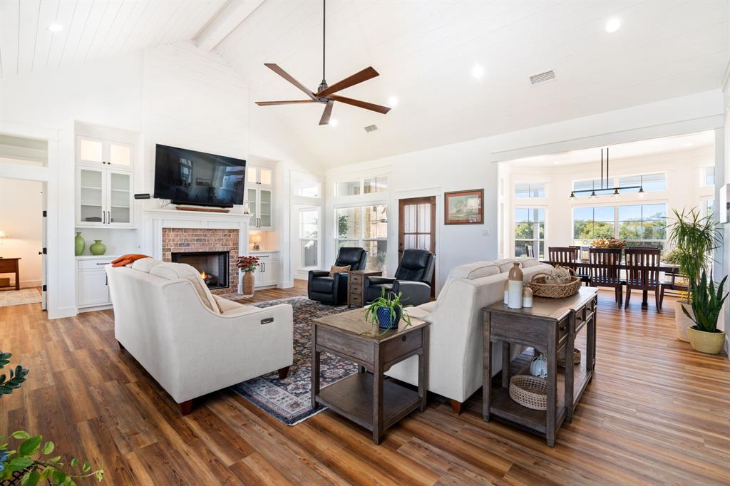 714 Bethel Road Waxahachie, TX 75167 - Photo 8 of 40 a living room with furniture a fireplace and a flat screen tv