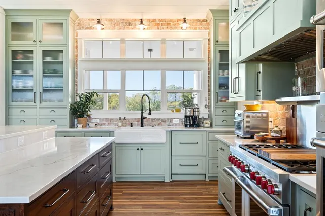 a kitchen with a sink stove and cabinets