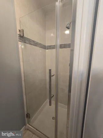 a bathroom with a glass shower door