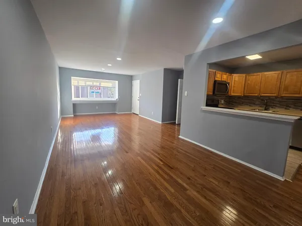 a view of a room with wooden floor and window