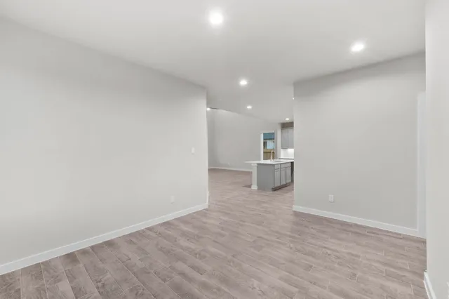 a view of a kitchen with a sink and a refrigerator