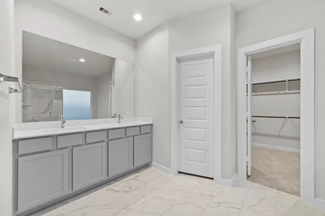a bathroom with a double vanity sink and a mirror