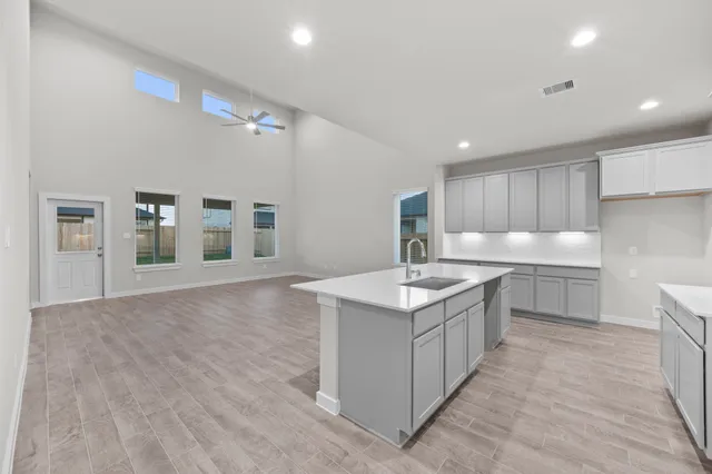 a kitchen with a sink stove and cabinets