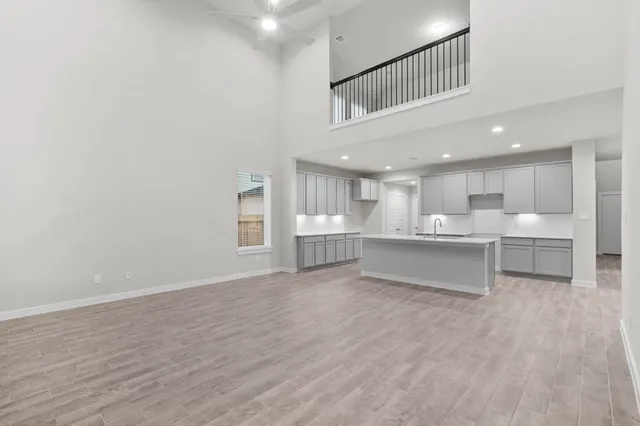 a view of kitchen with kitchen island and stainless steel appliances with cabinets