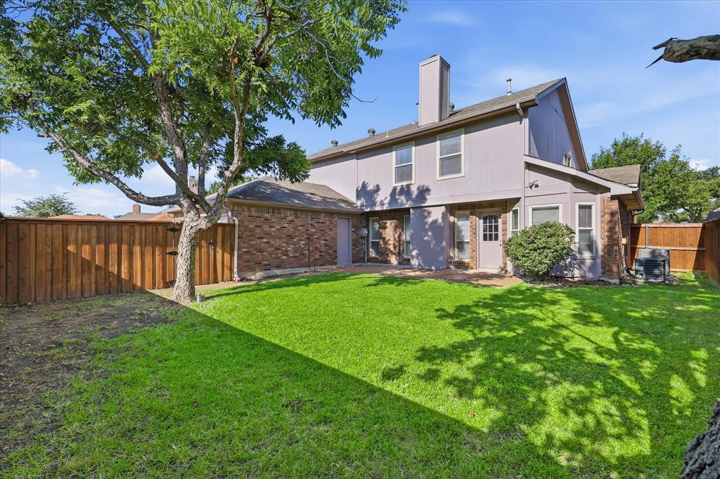 318 Lodge Road Coppell, TX 75019 - Photo 2 of 35 The spacious fenced yard provides a peaceful backdrop with mature trees, green lawn and direct access to the home.