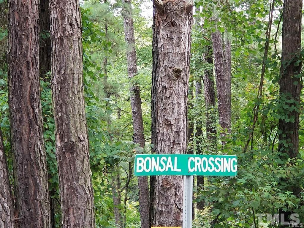 90 Bonsal Crossing Road New Hill, NC 27562 - Photo 5 of 11 a sign that is sitting next to a tree