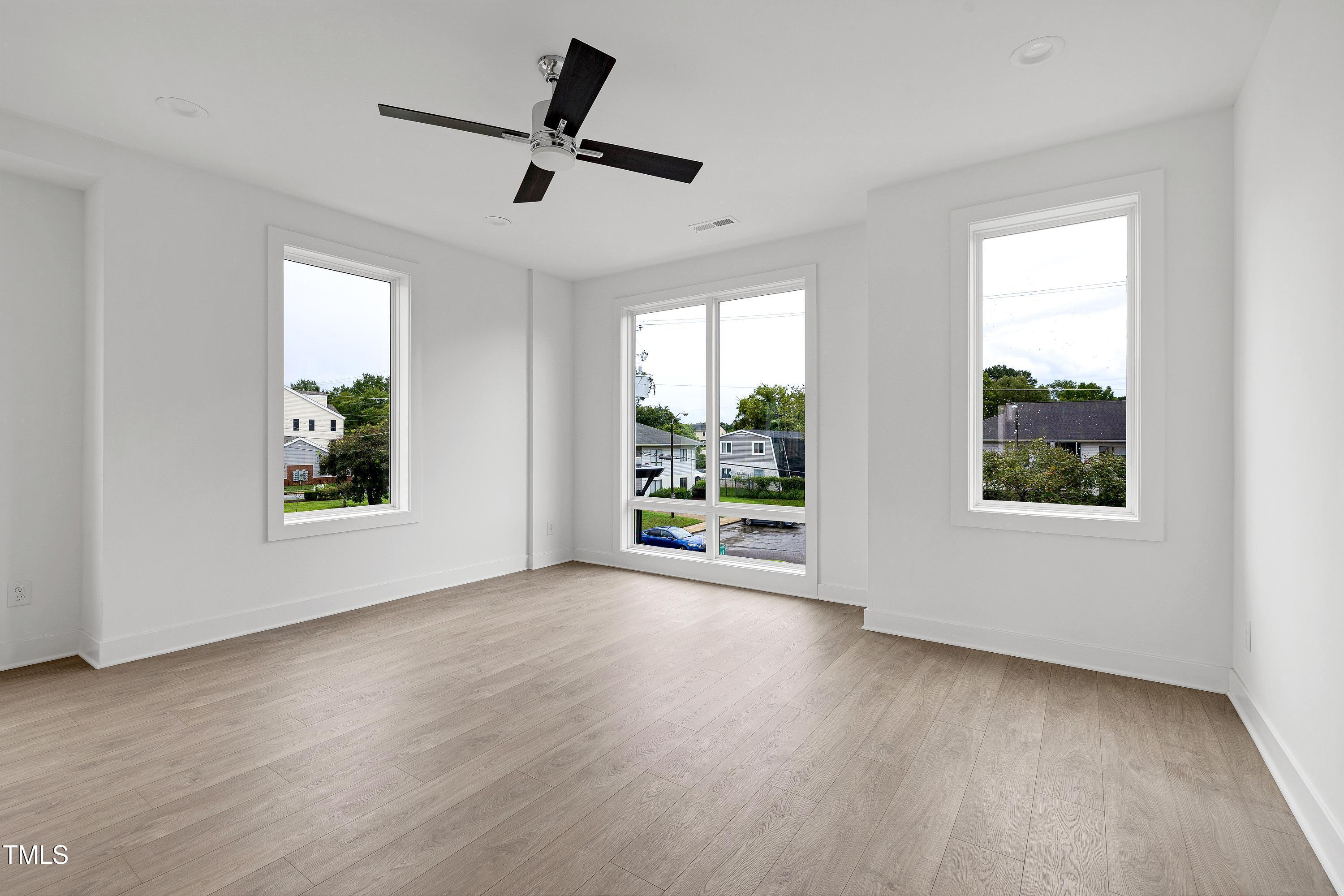 1412 Sawyer Road, Unit 101 Raleigh, NC 27610 - Photo 15 of 33 a view of an empty room with wooden floor and a window