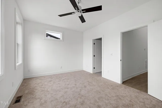 a view of empty room with ceiling fan