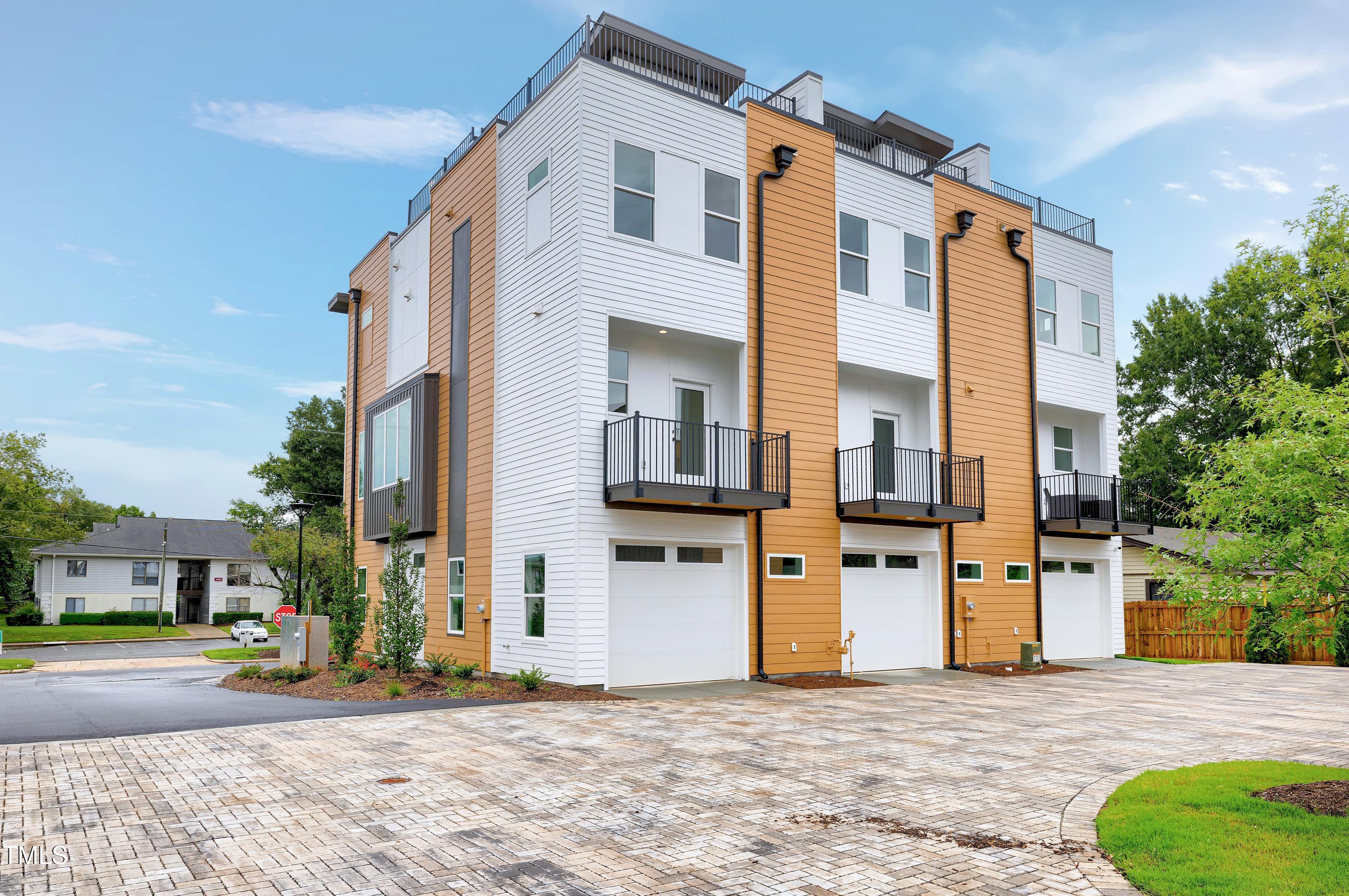 1412 Sawyer Road, Unit 101 Raleigh, NC 27610 - Photo 2 of 33 a front view of a house with a yard
