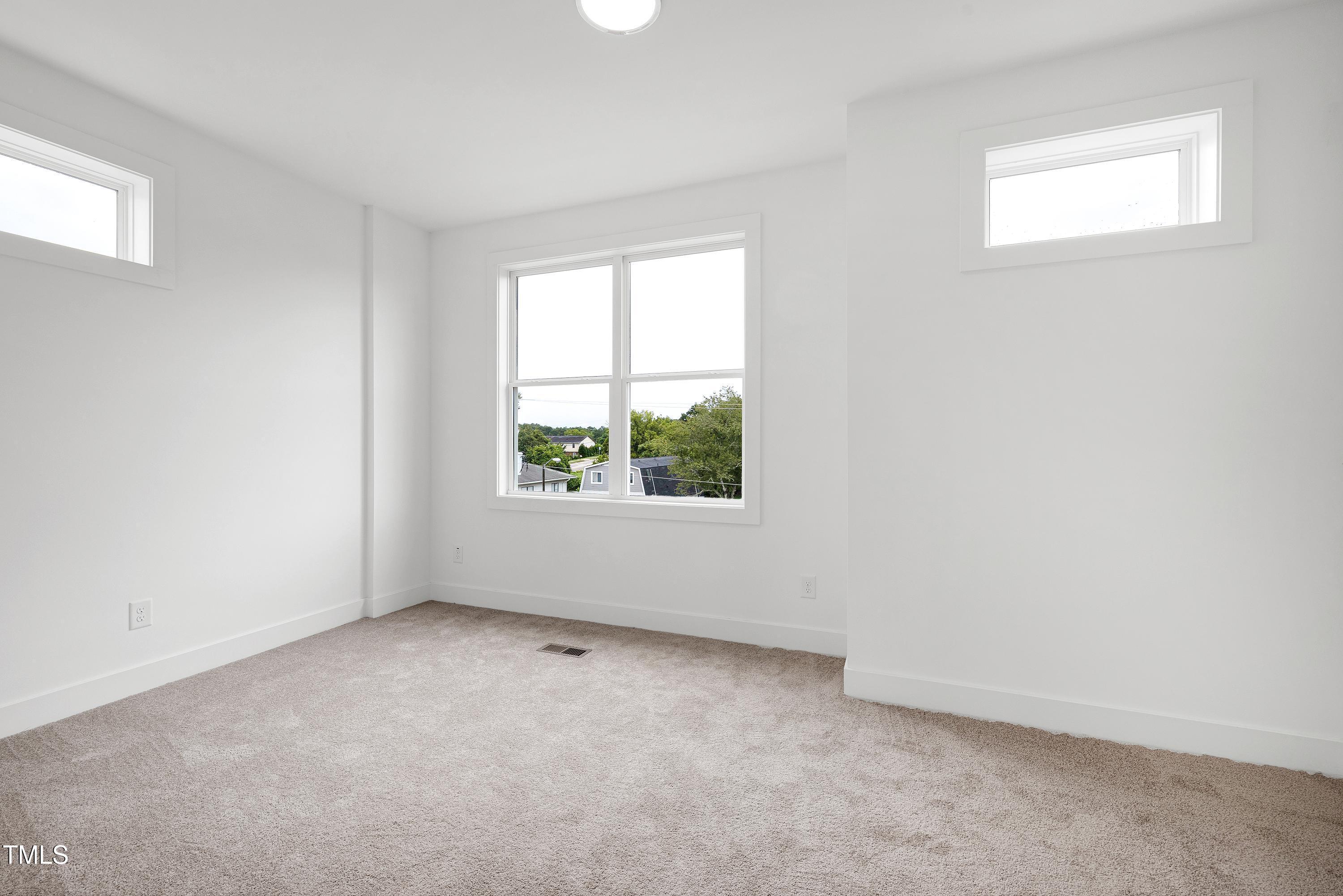 1412 Sawyer Road, Unit 101 Raleigh, NC 27610 - Photo 24 of 33 an empty room with windows