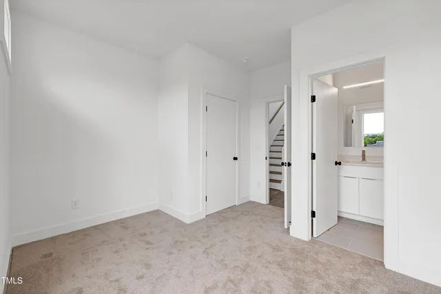 an empty room with an entrance to other room