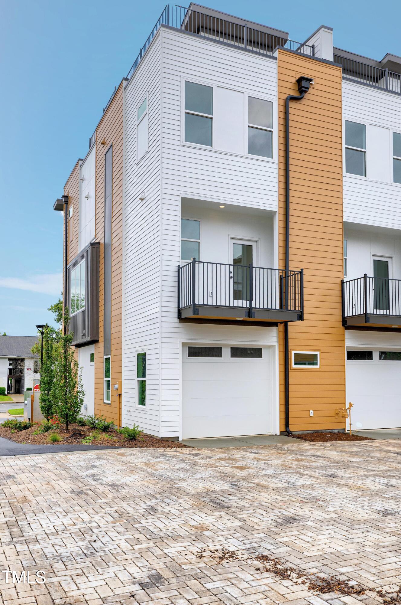 1412 Sawyer Road, Unit 101 Raleigh, NC 27610 - Photo 3 of 33 a front view of a house with a yard