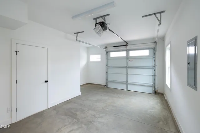 a view of a big building with a yard and plants