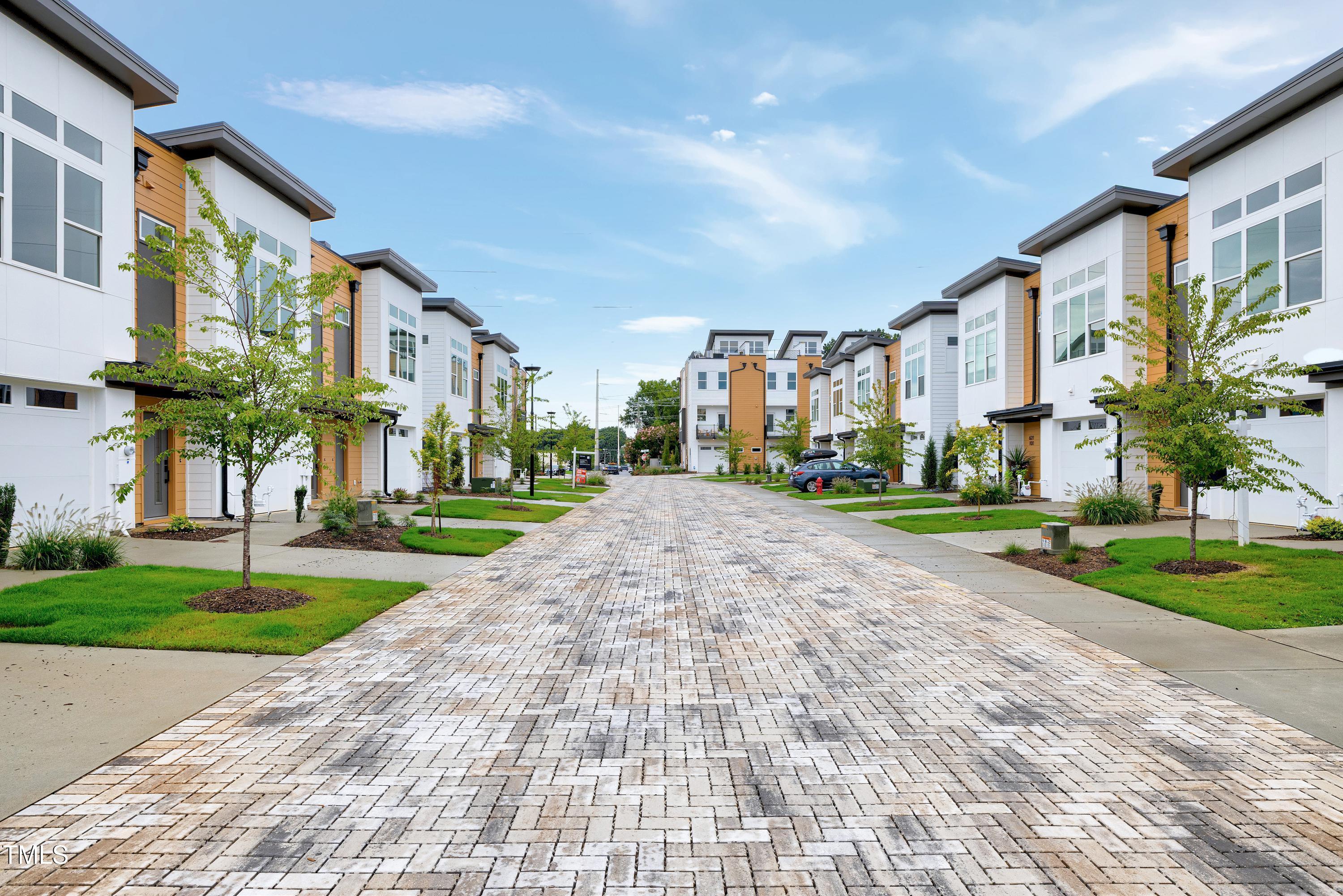 1412 Sawyer Road, Unit 101 Raleigh, NC 27610 - Photo 32 of 33 a view of a big building with a yard and plants