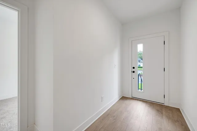 a view of an empty room and wooden floor
