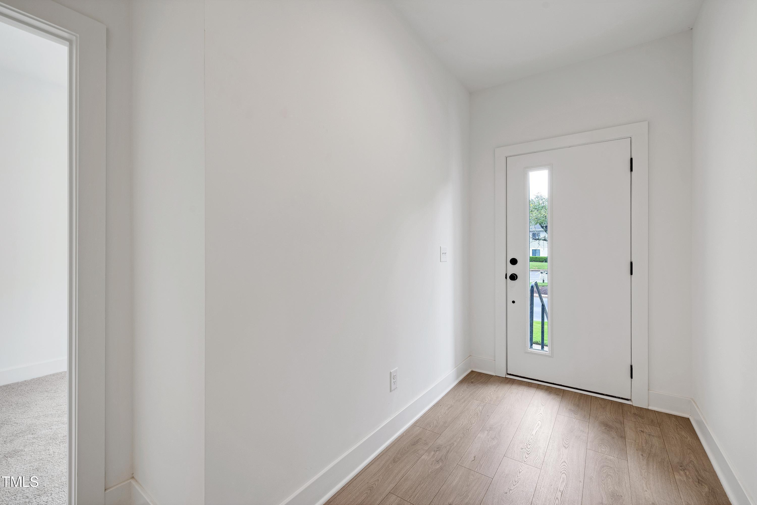 1412 Sawyer Road, Unit 101 Raleigh, NC 27610 - Photo 5 of 33 a view of an empty room and wooden floor