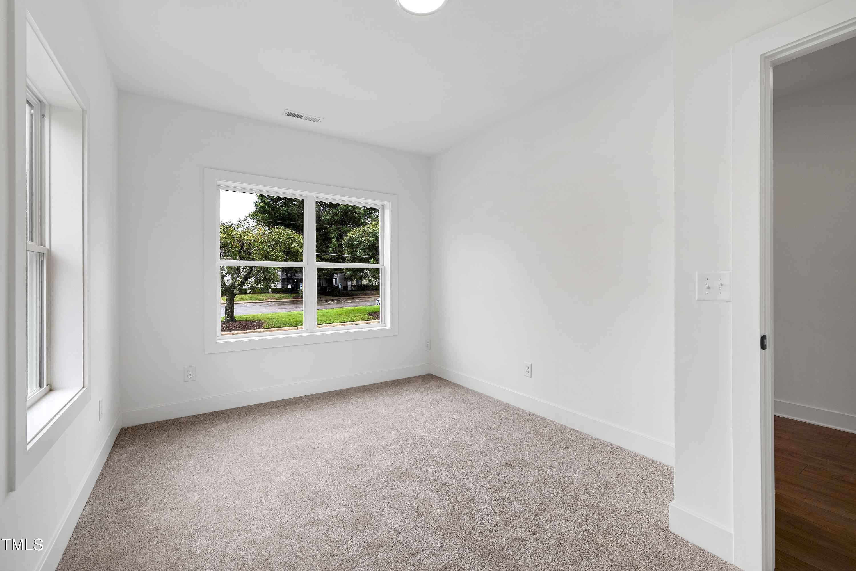 1412 Sawyer Road, Unit 101 Raleigh, NC 27610 - Photo 6 of 33 an empty room with windows