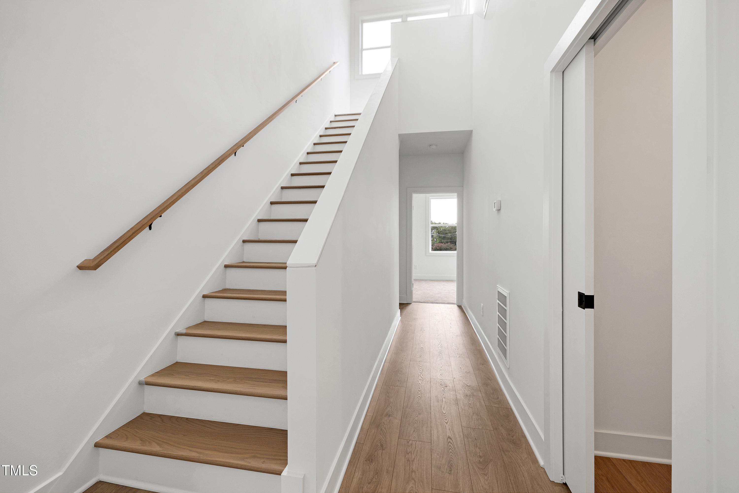1412 Sawyer Road, Unit 101 Raleigh, NC 27610 - Photo 9 of 33 a view of a hallway with wooden floor and entryway