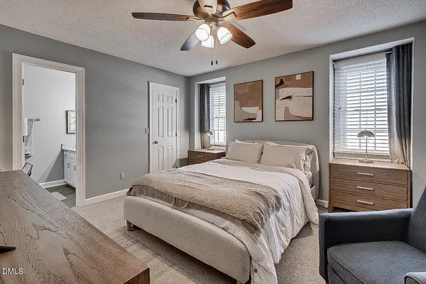 a bedroom with a large bed and a chandelier