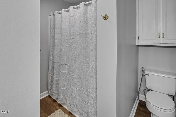 a large bed sitting in a bedroom next to a window
