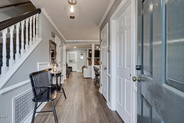 a view of a hallway with wooden floor and stairs