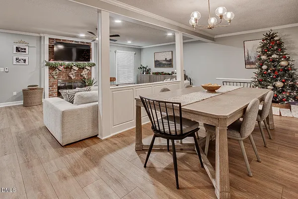a view of a dining room with furniture and wooden floor