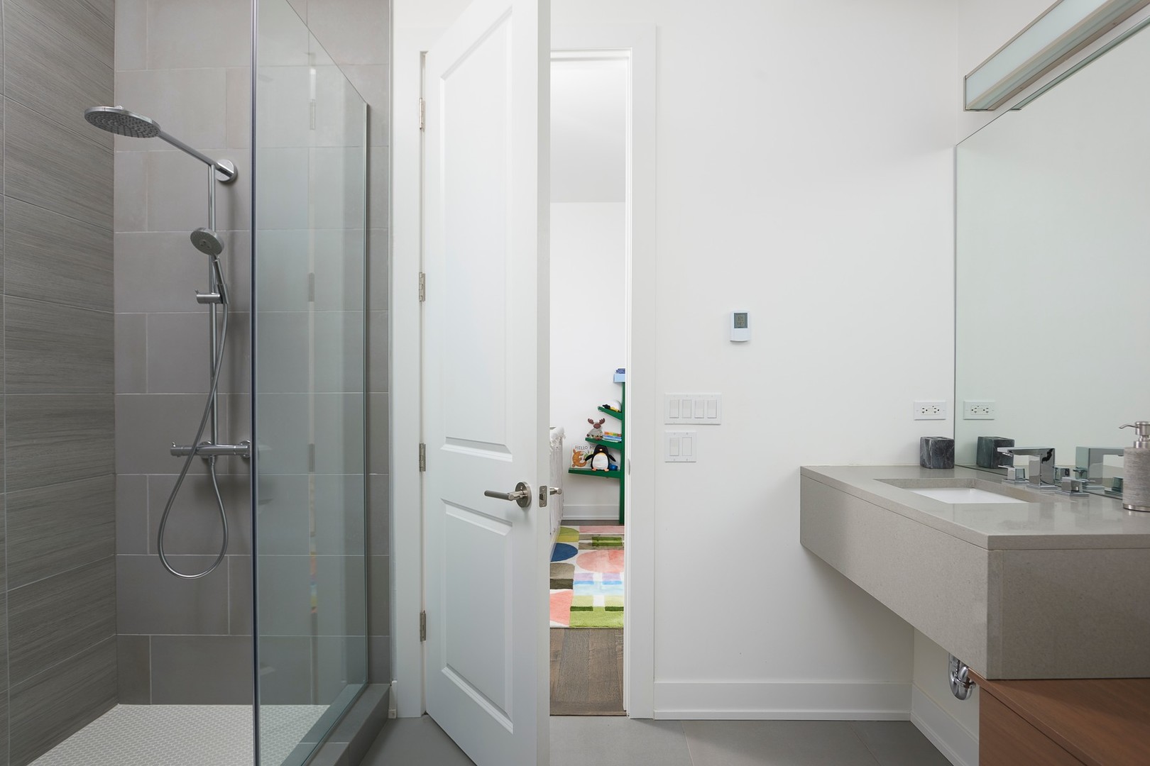 440 North Halsted Street, Unit 3A Chicago, IL 60642 - Photo 13 of 18 a bathroom with a sink a mirror and shower