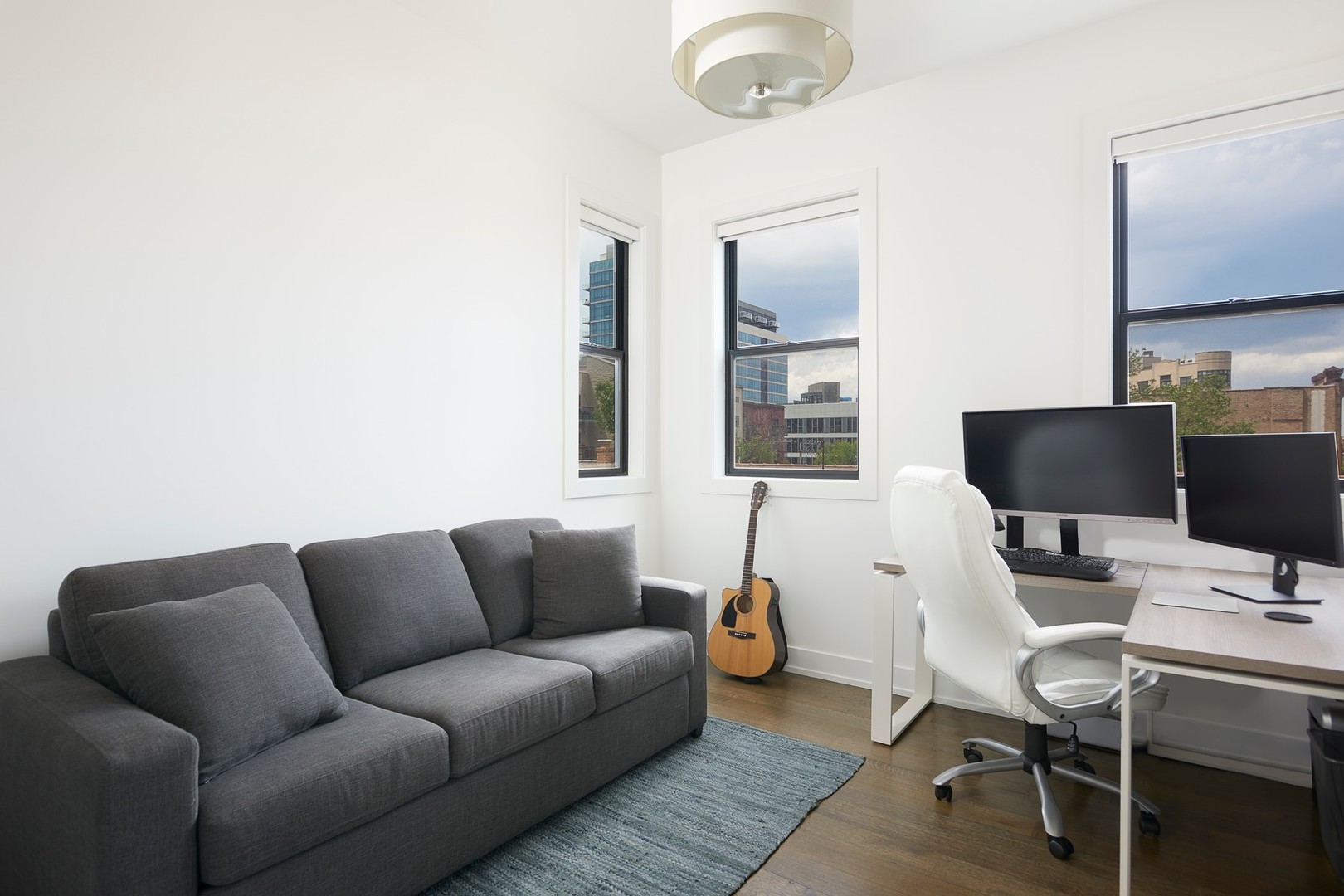 440 North Halsted Street, Unit 3A Chicago, IL 60642 - Photo 14 of 18 a living room with furniture a flat screen tv and a large window