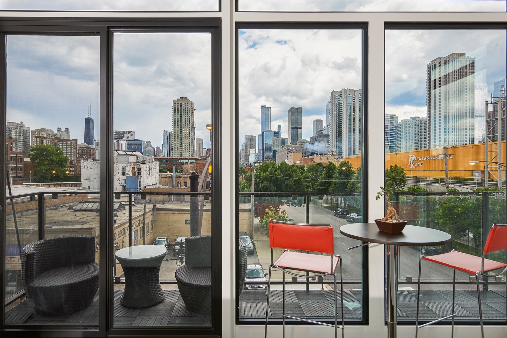 440 North Halsted Street, Unit 3A Chicago, IL 60642 - Photo 16 of 18 a view of a city from a chair in the balcony