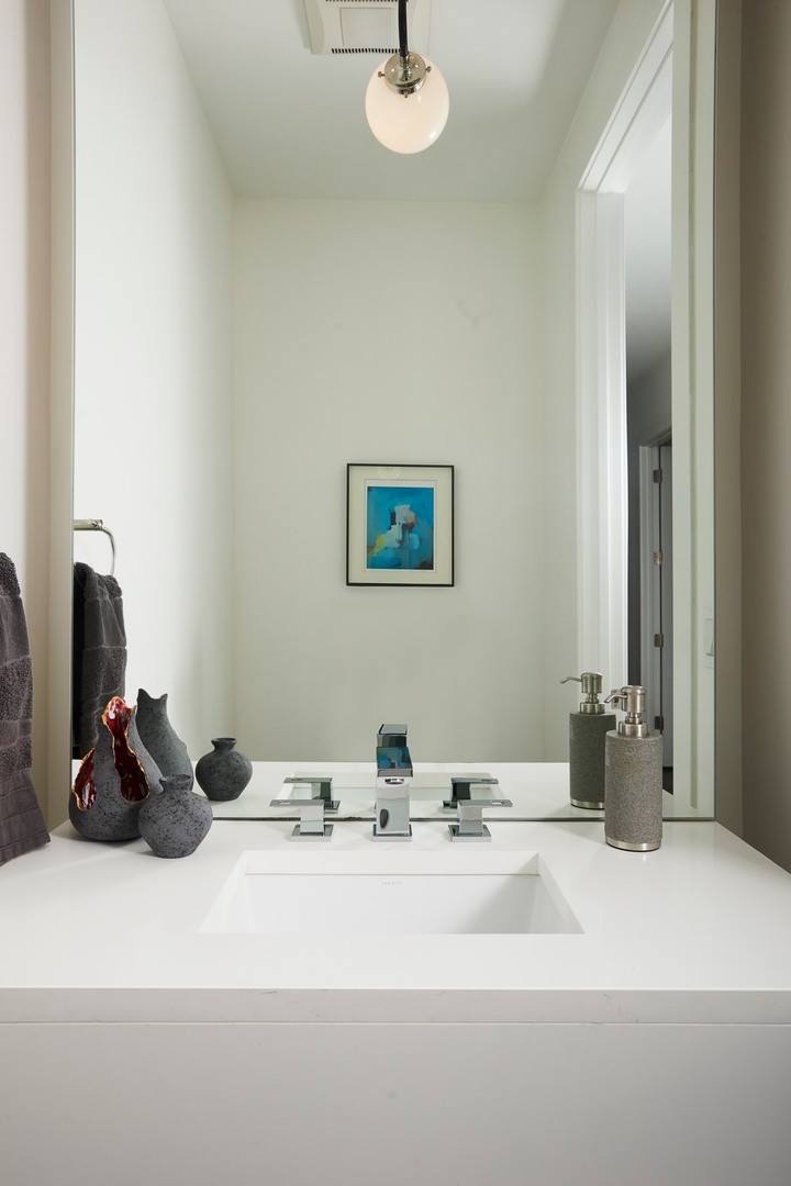 440 North Halsted Street, Unit 3A Chicago, IL 60642 - Photo 17 of 18 a bathroom with a sink and a mirror