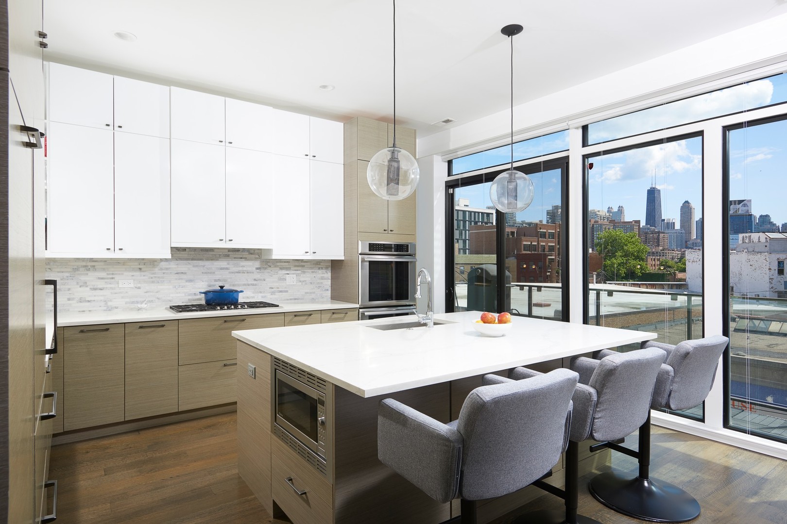 440 North Halsted Street, Unit 3A Chicago, IL 60642 - Photo 4 of 18 a kitchen with a table chairs sink and cabinets