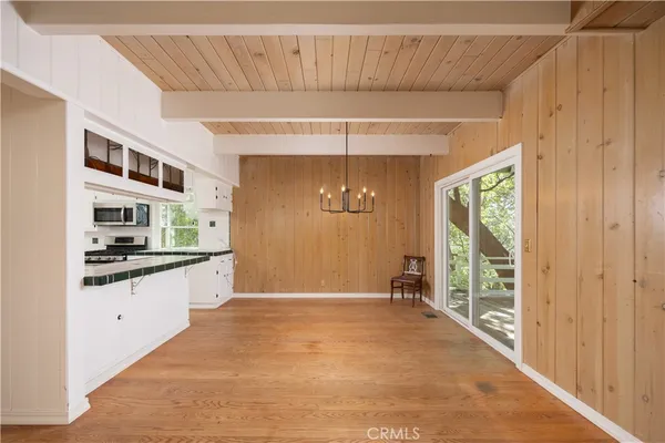 a kitchen with stainless steel appliances kitchen island granite countertop a refrigerator and a sink