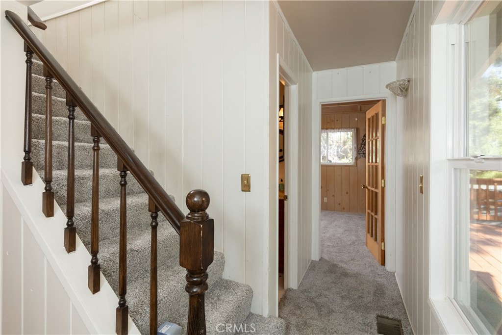 1268 Aleutian Drive Lake Arrowhead, CA 92352 - Photo 14 of 33 a view of a hallway with wooden floor and staircase