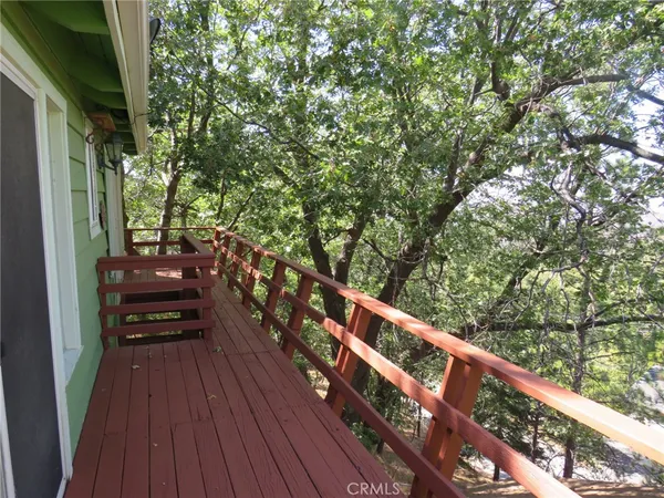 a view of a balcony with wooden fence and floor