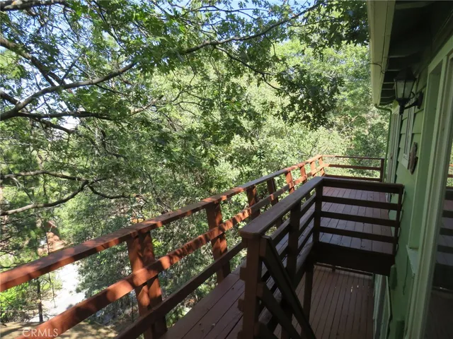 a view of a balcony with wooden fence and floor