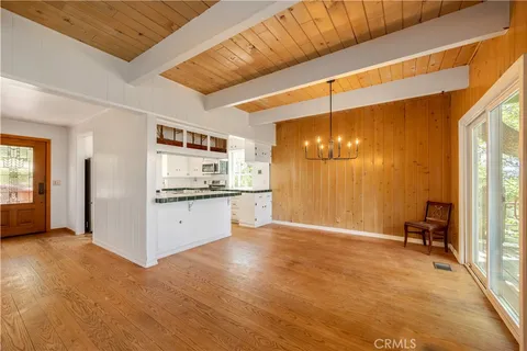 a view of a kitchen with refrigerator and window