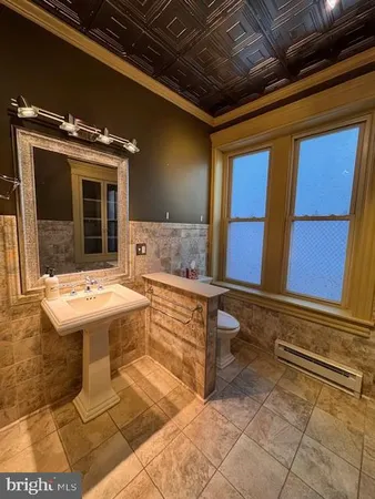 a kitchen with stainless steel appliances granite countertop wooden cabinets counter space and a window