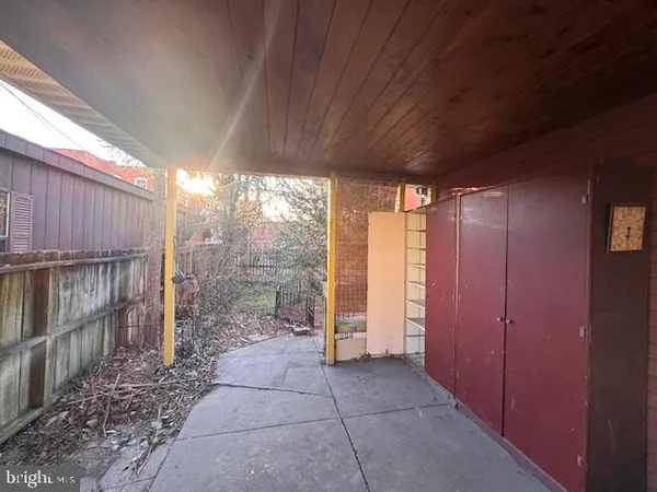 an empty room with windows and fireplace