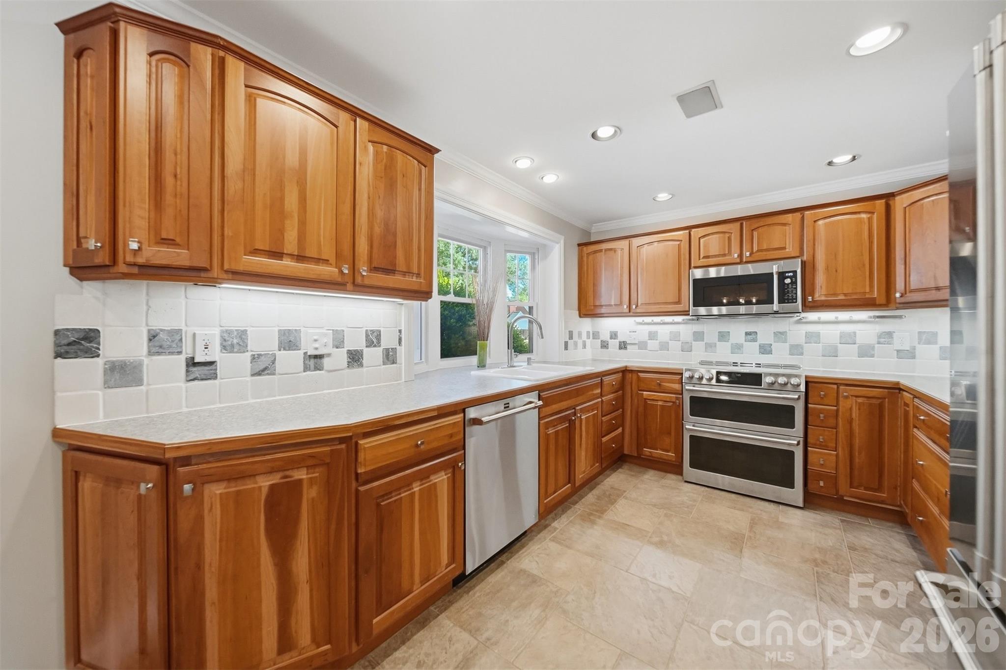 543 5th Street Northwest Hickory, NC 28601 - Photo 13 of 43 a kitchen with stainless steel appliances granite countertop a stove top oven a sink dishwasher and a refrigerator with cabinets