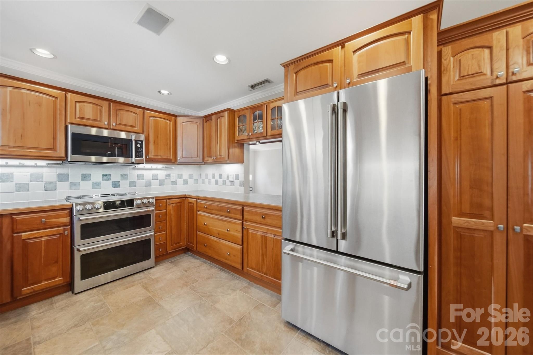 543 5th Street Northwest Hickory, NC 28601 - Photo 14 of 43 a kitchen with stainless steel appliances granite countertop a refrigerator and a stove top oven
