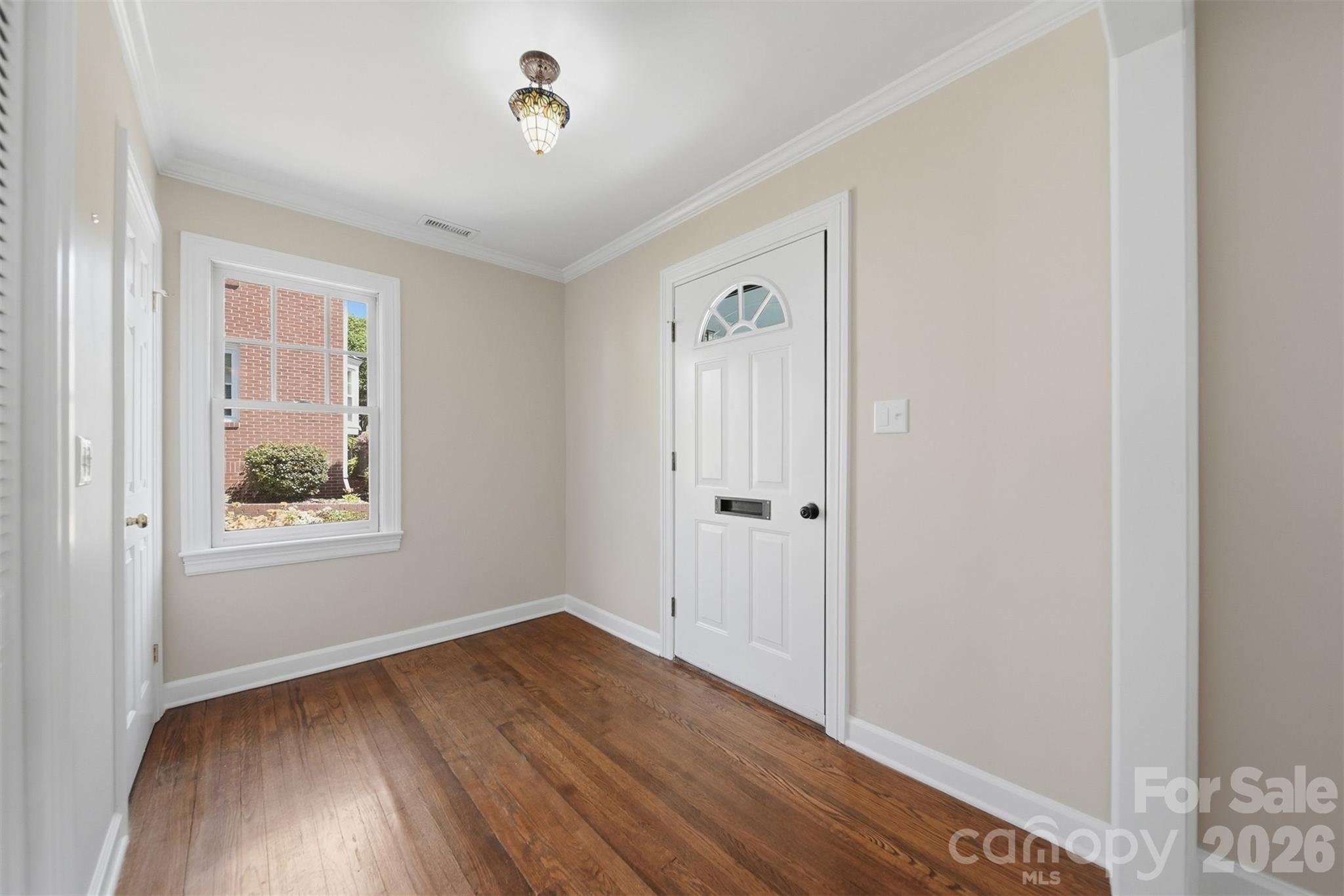 543 5th Street Northwest Hickory, NC 28601 - Photo 3 of 43 a view of an empty room with wooden floor and a window