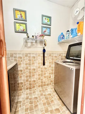 a bathroom with a sink a window and a shower