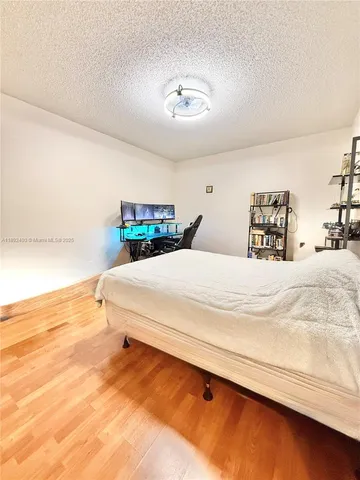 a bedroom with a bed and a night stand