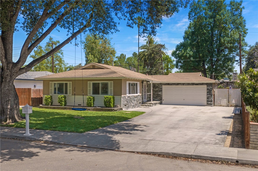 4869 Serrano Place Riverside, CA 92504 - Photo 5 of 40 Well-kept front yard with a mature shade tree, green lawn, and a clean, easy-care exterior.
