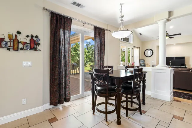 a view of a dining room and livingroom with furniture window and wooden floor