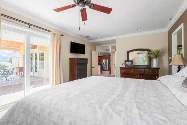 a large bedroom with a large bed and a flat tv screen